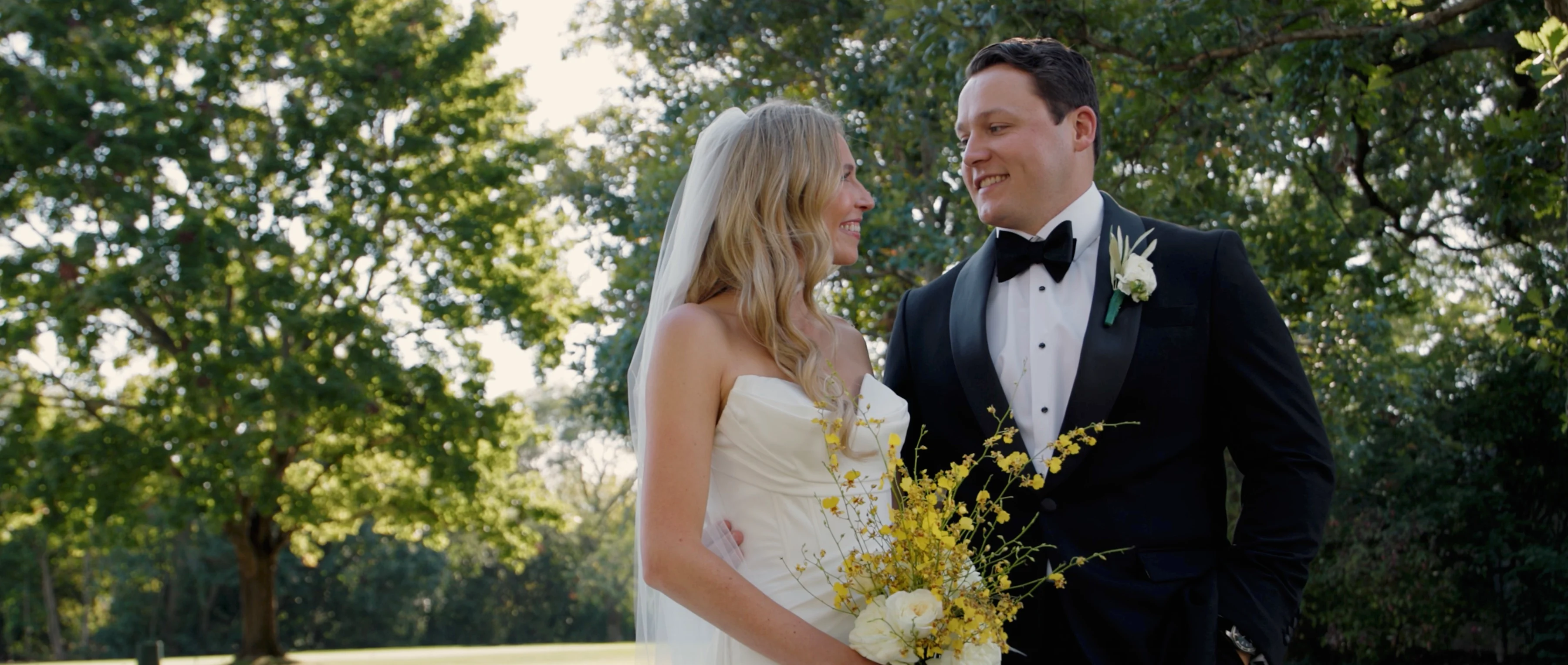 bride and groom smiling for videographer at a Lake Forest wedding